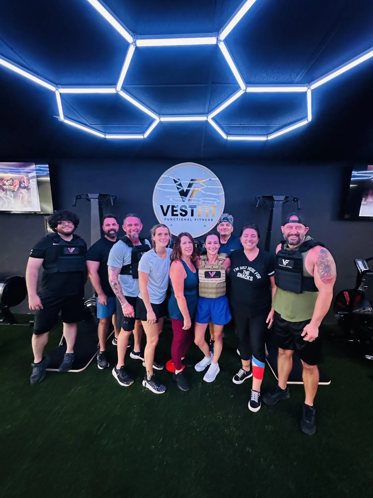 VestFit members in weighted vests together under the studio's VestFit sign.